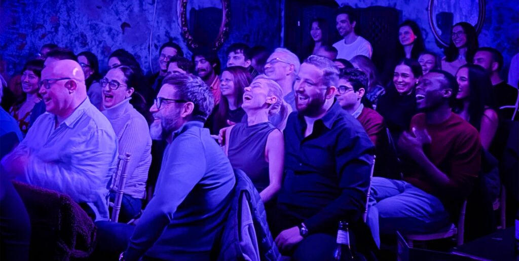 Comedy club audience laughing